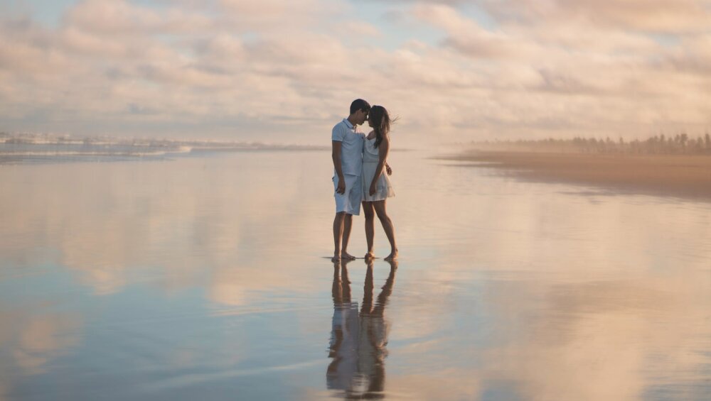 photo of couple standing on water