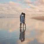 photo of couple standing on water