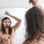 a man applying cosmetic product on hair with a dropper