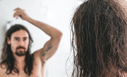 a man applying cosmetic product on hair with a dropper