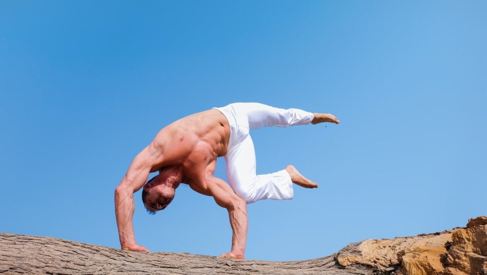 man wearing white pants under blue sky