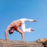 man wearing white pants under blue sky