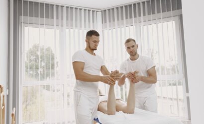 men in white shirts massaging a person s feet