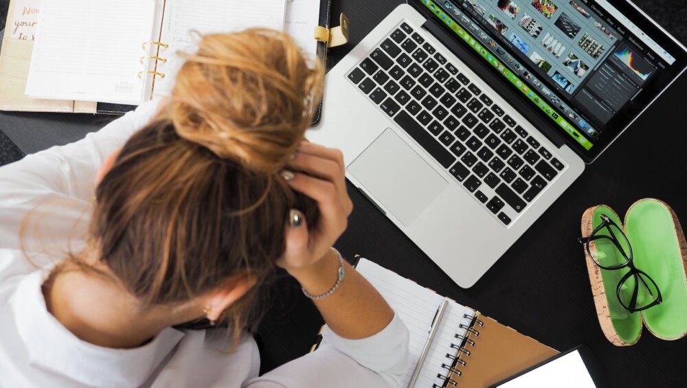 woman sitting in front of macbook