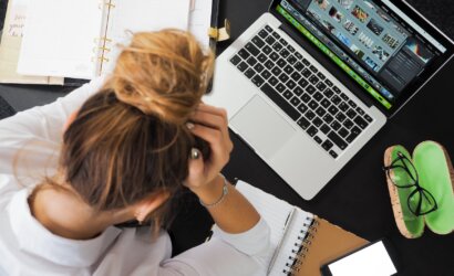 woman sitting in front of macbook