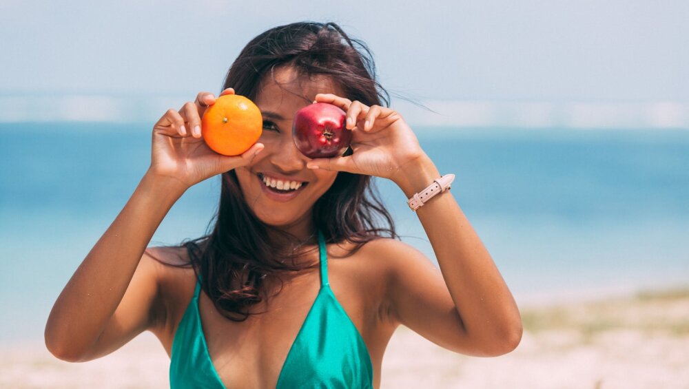a woman holding fruits on both hands