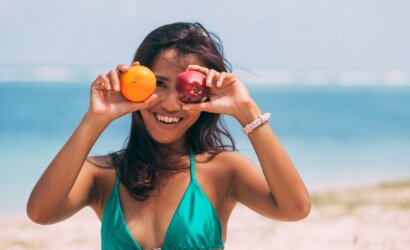 a woman holding fruits on both hands