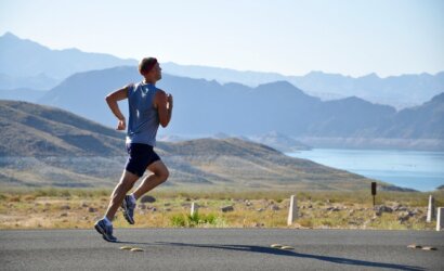 man running on side of road