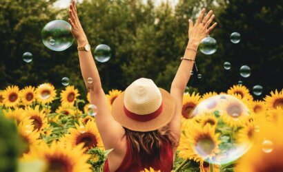 woman surrounded by sunflowers