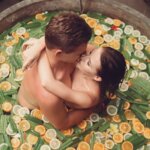 sensual couple hugging and kissing in stone fruit bath