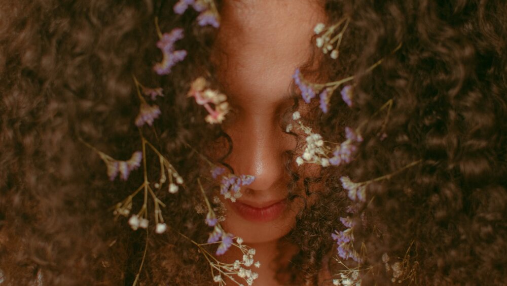 unrecognizable woman with curly hair