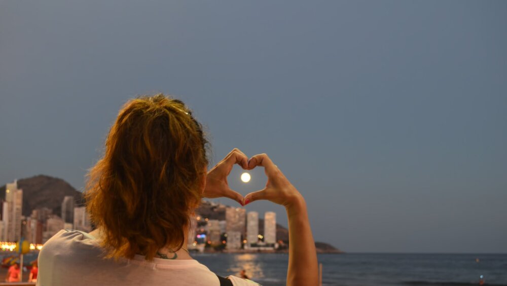 woman showing heart hand sign