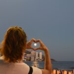 woman showing heart hand sign