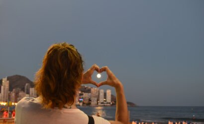 woman showing heart hand sign