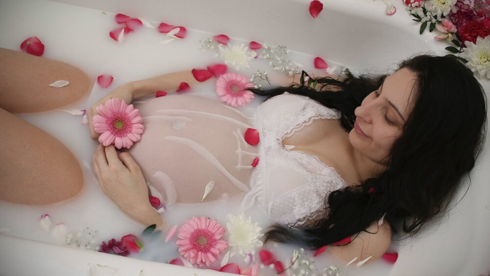 pregnant woman lying in the bathtub