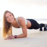 woman exercising bear body of water