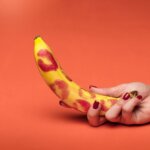a person holding yellow banana fruit