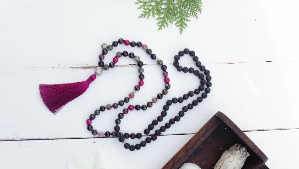 a close up shot of a mala bead necklace