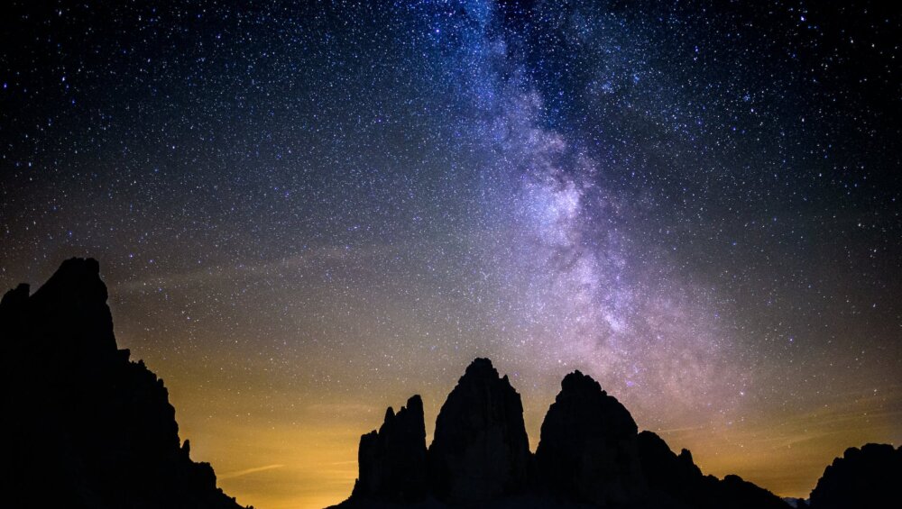 silhouette photography of rocky mountains under starry sky