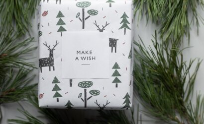 wrapped new year present box placed among coniferous branches