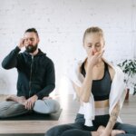 a man and a woman meditating practicing breathing control