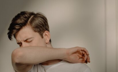 a sick man covering his mouth